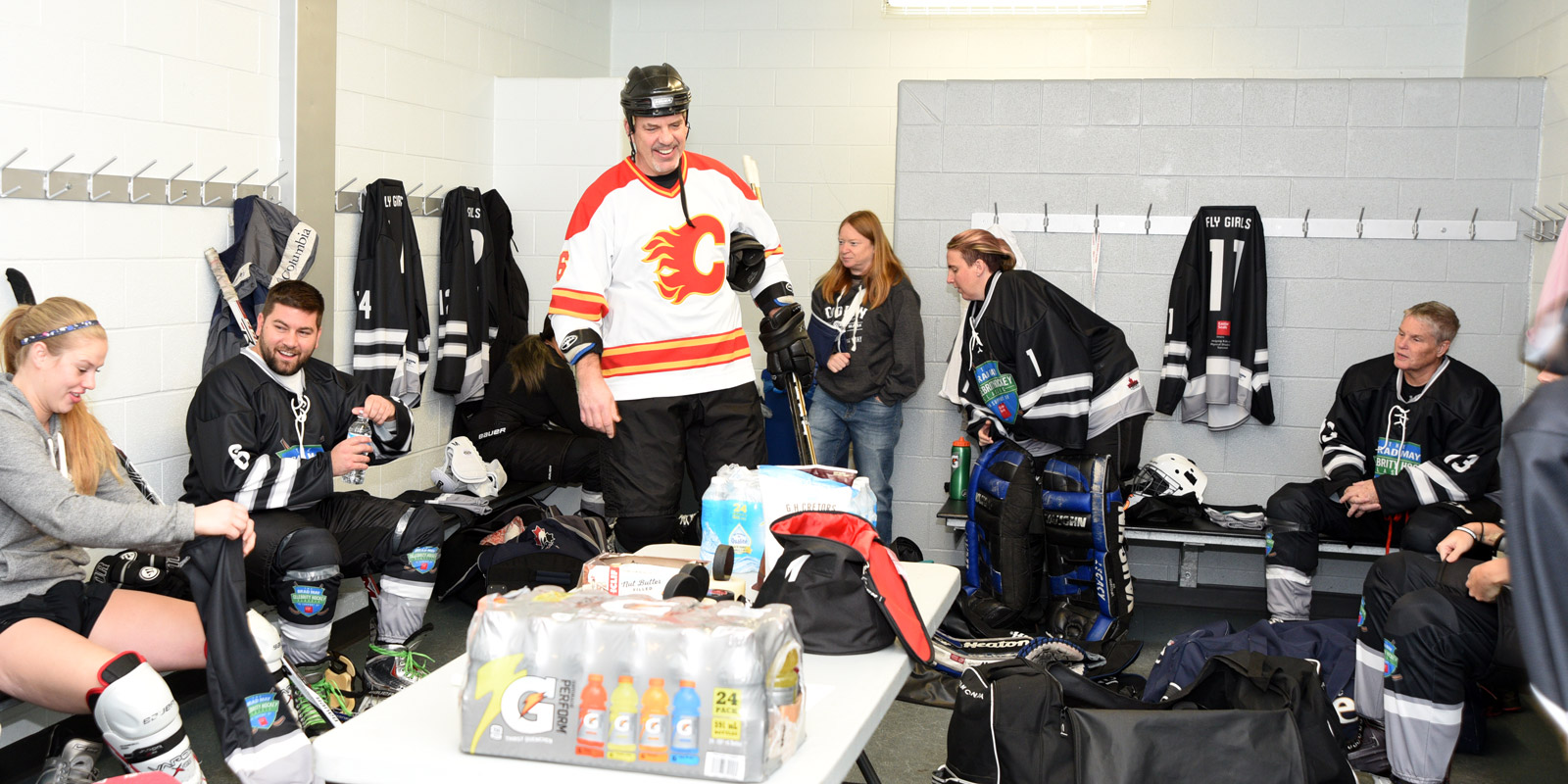 Players gear up inside a locker room at Sixteen Mile Arena
