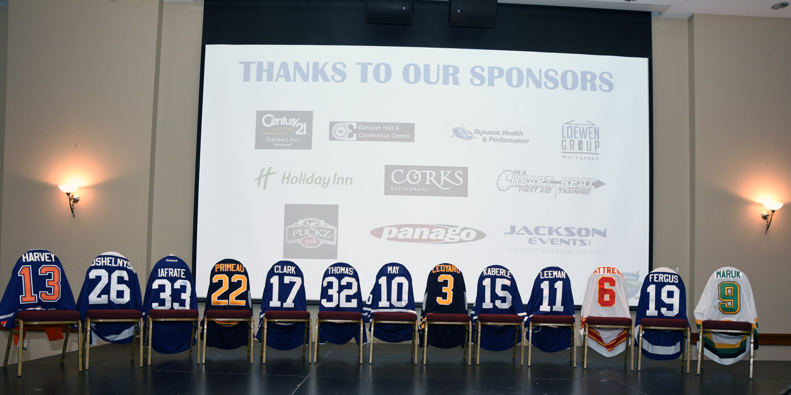 The sponsors logos displayed on a projector