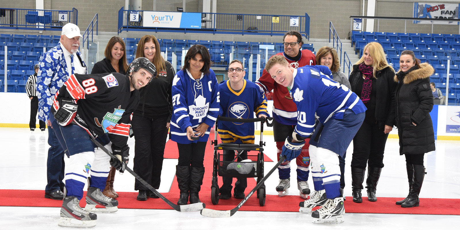 Brad May does the ceremonial puck drop with one of the players