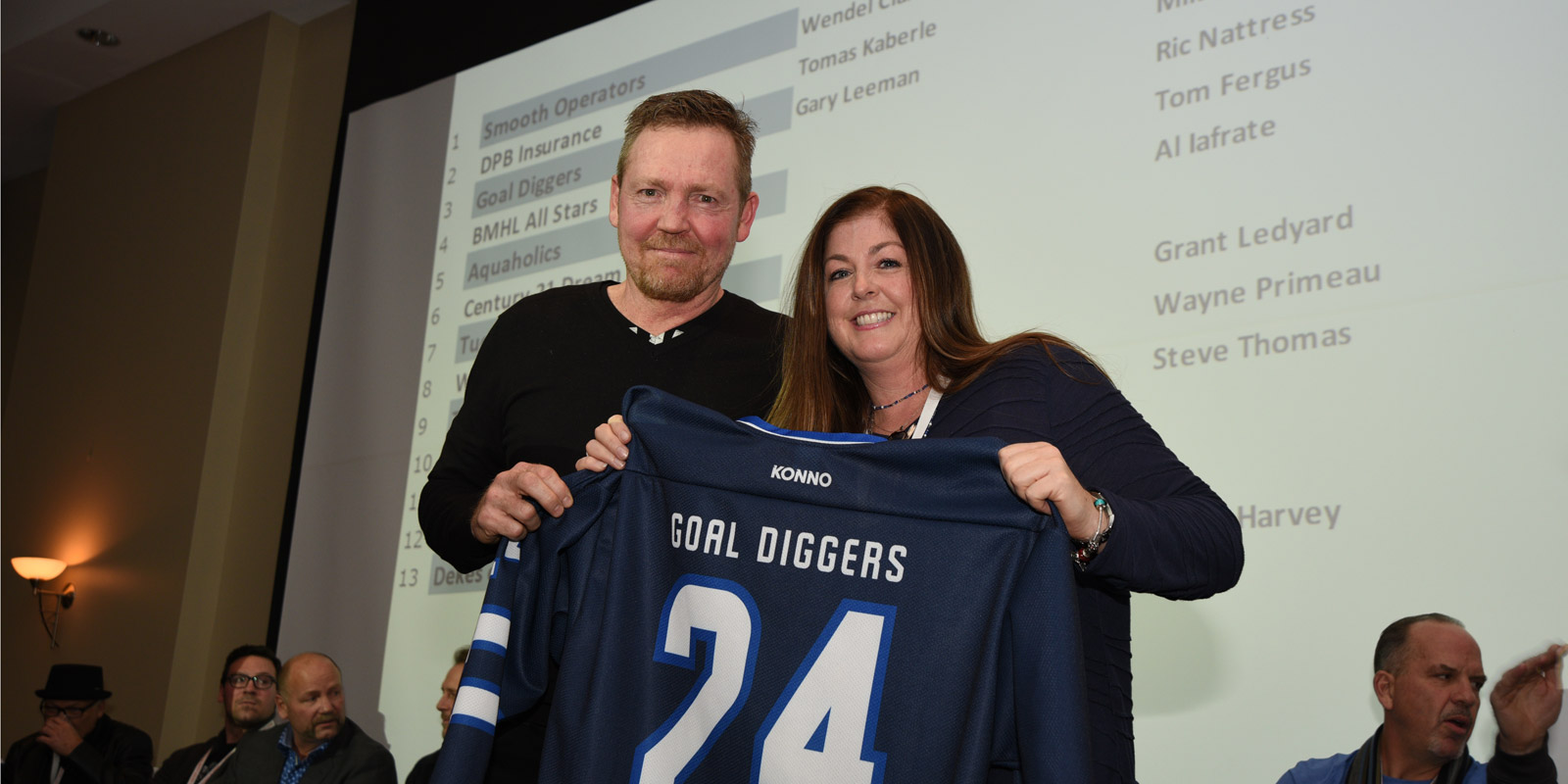 Gary Leeman accepts a jersey for the Goal Diggers at the draft party