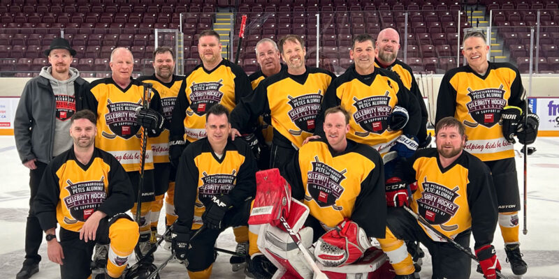 A team poses on the ice.